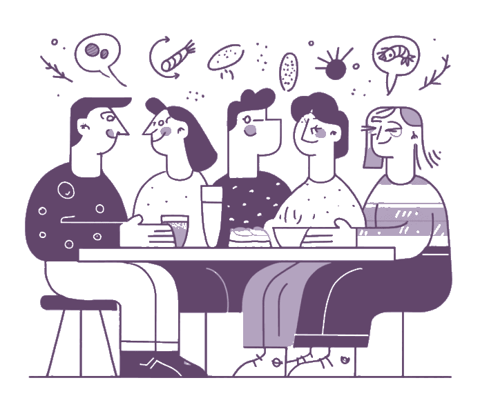 People gathering around a table with food